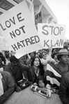 Crowd of protesters holding signs at Ku Klux Klan march in downtown Dallas by Rodger Mallison