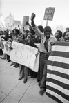 Crowd of protesters holding signs at Ku Klux Klan march in downtown Dallas by Rodger Mallison