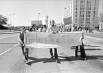 Protesters holding banner at Ku Klux Klan march in downtown Dallas by Rodger Mallison