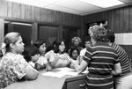 Noncitizens in the office of Denver Avenue Elementary School with their children by Joe McAulay