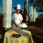 Robert Meacham posed in front of burned ruins of River Crest Country Club