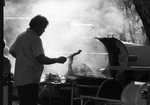 Robert Gardner barbecuing ribs for Juneteenth celebration in Sycamore Park by Norm Tindell