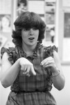 Hearing-impaired student uses sign language during class by Jerry W. Hoefer