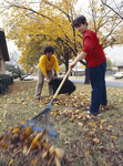 Susie Rush and Mike Pipes raking leaves by Willis Knight