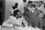 Donald Curry signing autographs at the Lena Pope Home by James Masters