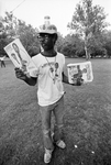 Man selling promotional items during Juneteenth Blues Festival in Sycamore Park by Joe Giron