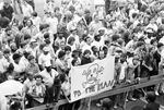 Crowd of protesters holding banner at Ku Klux Klan march in downtown Dallas by Joe Giron
