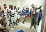 Dunbar High School basketball coach Robert Hughes with team by Rodolfo Gonzalez