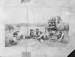 Chuckwagon with 6 cowboys eating