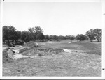 Golf course, hole #16 to green with a bridge on the left