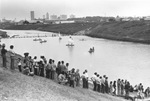 People in canoes and sailboats on the Trinity River at Trinity Park