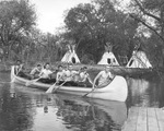 Six Flags Over Texas, Arlington; men rowing a canoe past an Indian Village