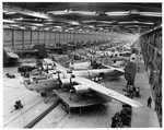 B-24 assembly line in hangar at General Dynamics (or may be Consolidated Vultee Aircraft Corporation), Fort Worth