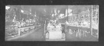 Men standing by the counters of a dry goods store in Thurber, Texas