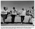 African-American students holding signs and marching to support Provost Taylor to be appointed University of Texas at Arlington (U. T. A.) interim president when President Amacher resigned