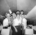 Arlington State College Rebels football team in flight, with American Airlines stewardess, to 11th Annual Junior Rose Bowl