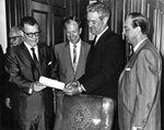 Governor John Connally holding bill for transferring Arlington State College to the University of Texas System