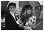 Members of the University of Texas at Arlington homecoming court under an umbrella