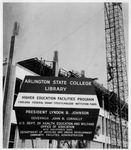 Construction at Arlington State College Central Library; sign near construction indicating amount of federal grant and institution funds for renovation