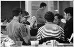 Male students playing cards in UTA's Hereford Student Center