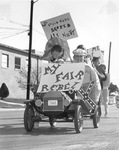 Rebel car with UTA students carrying signs