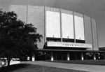 Student walking near newly constructed Texas Hall auditorium, ASC campus