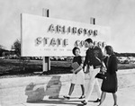 Three students walking in front of ASC sign