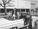 Students in convertible car outside ASC's E.H. Hereford Student Center