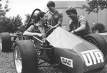 UTA Mechanical Engineering students (not identified) win First Place trophy with race car and $1,000