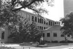 A student sitting in front of water fountain at UTA's Preston Hall