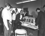 M. L. Pierce demonstrates an IBM computer at UTA