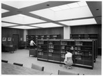 Two women shelving books in newly renovated Central Library at University of Texas at Arlington (U. T. A.) by Squire Haskins Photography Inc.