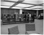 Two women shelving books in newly renovated Central Library at University of Texas at Arlington (U. T. A.) by Squire Haskins Photography Inc.