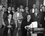 Texas Governor Price Daniel (seated) signing bill making Arlington State College (A. S. C.) a four-year college