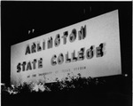 Arlington State College (A. S. C.) sign at night