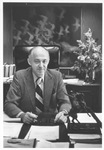 UTA President Wendell Nedderman seated at his desk