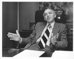 UTA President Wendell Nedderman seated behind his desk