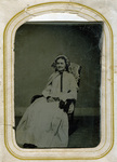 Lady in white dress sitting in chair posing for photo portrait