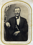 Man with heavy beard sitting for photo portrait