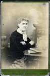 Cabinet card of unidentified woman sitting at desk by Cheney and Christman