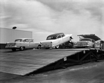 Cars on flatbed trailer at General Motors plant by W. D. Smith