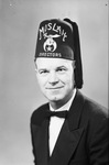 Portrait photograph of Tom Renfro in Directors fez by W. D. Smith