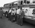 Shriners with family standing in front of bus by W. D. Smith