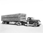 A man smiling and posing in front of his semi-trailer. by W. D. Smith