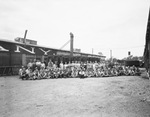 Workers at the Hyde Corporation posing for a photograph outside the factory by W. D. Smith