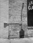 An energy meter installed on a building at ground level by W. D. Smith