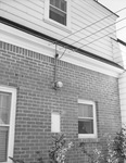 An energy meter installed on the side of a house by W. D. Smith