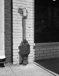 An energy meter installed on a building at ground level by W. D. Smith