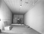 Man standing in mostly empty room by W. D. Smith