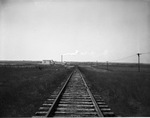 Men working on telephone wires near a railroad track by W. D. Smith